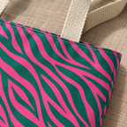 Close-up of the hot pink and emerald green zebra stripes and handle of the tote bag