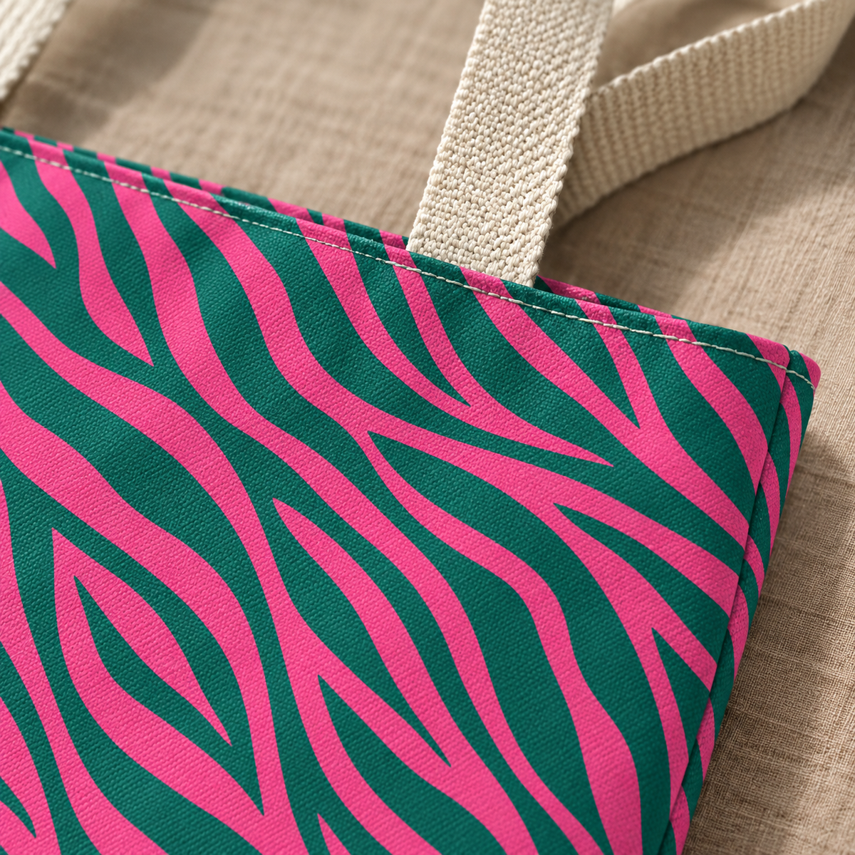 Close-up of the hot pink and emerald green zebra stripes and handle of the tote bag