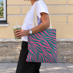 Woman walking with the pink green zebra print tote bag on her shoulder and an iced drink