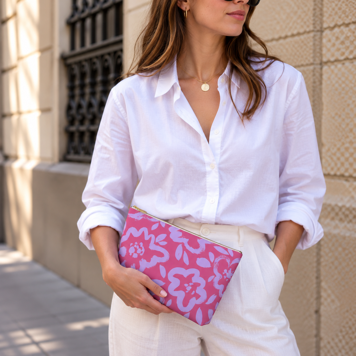 Model holding the pink lavender floral makeup bag like a clutch