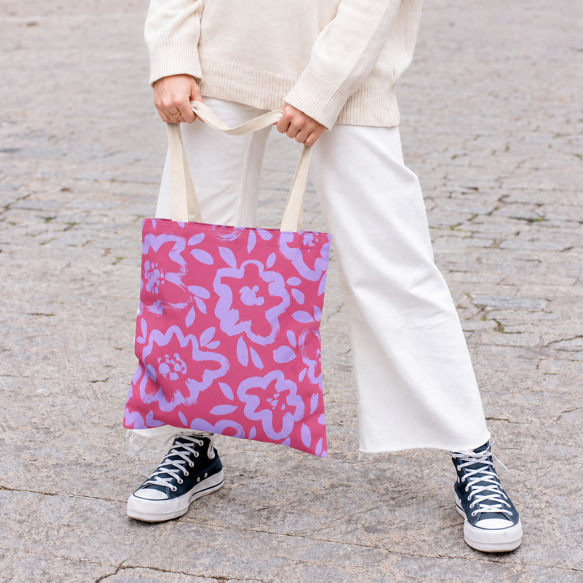 Model holding the pink lavender floral tote bag by its handles