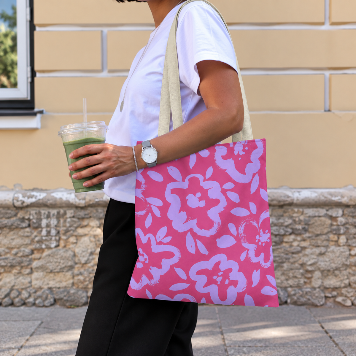 Woman with an iced drink wearing the pink lavender floral tote bag on her shoulder