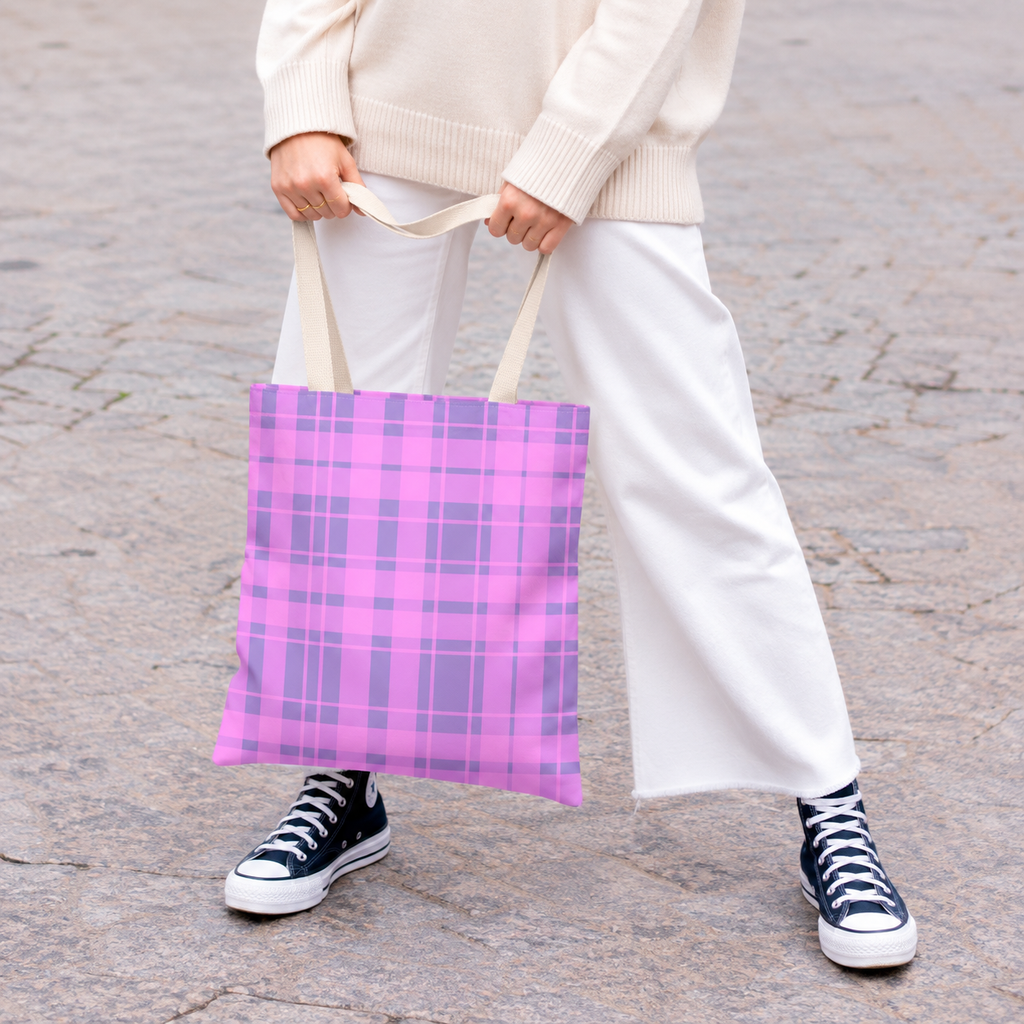 Model holding the pink lavender plaid tote bag by its handles