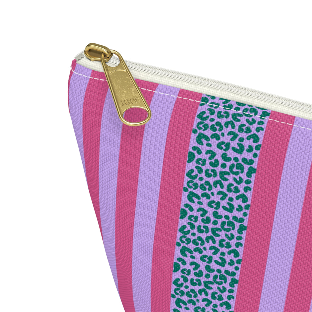 Close-up of the pink stripes, blue leopard print band and gold zipper pull on the makeup bag
