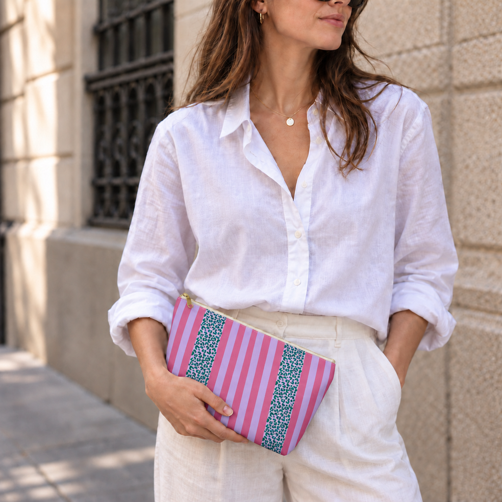 Model holding the Pink Leopard Striped makeup bag like a clutch