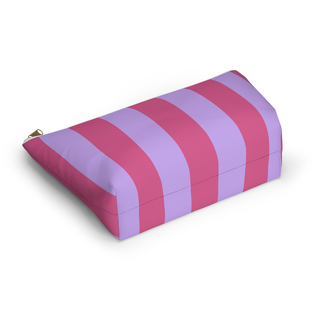 Angled view of the striped makeup bag lying on its side