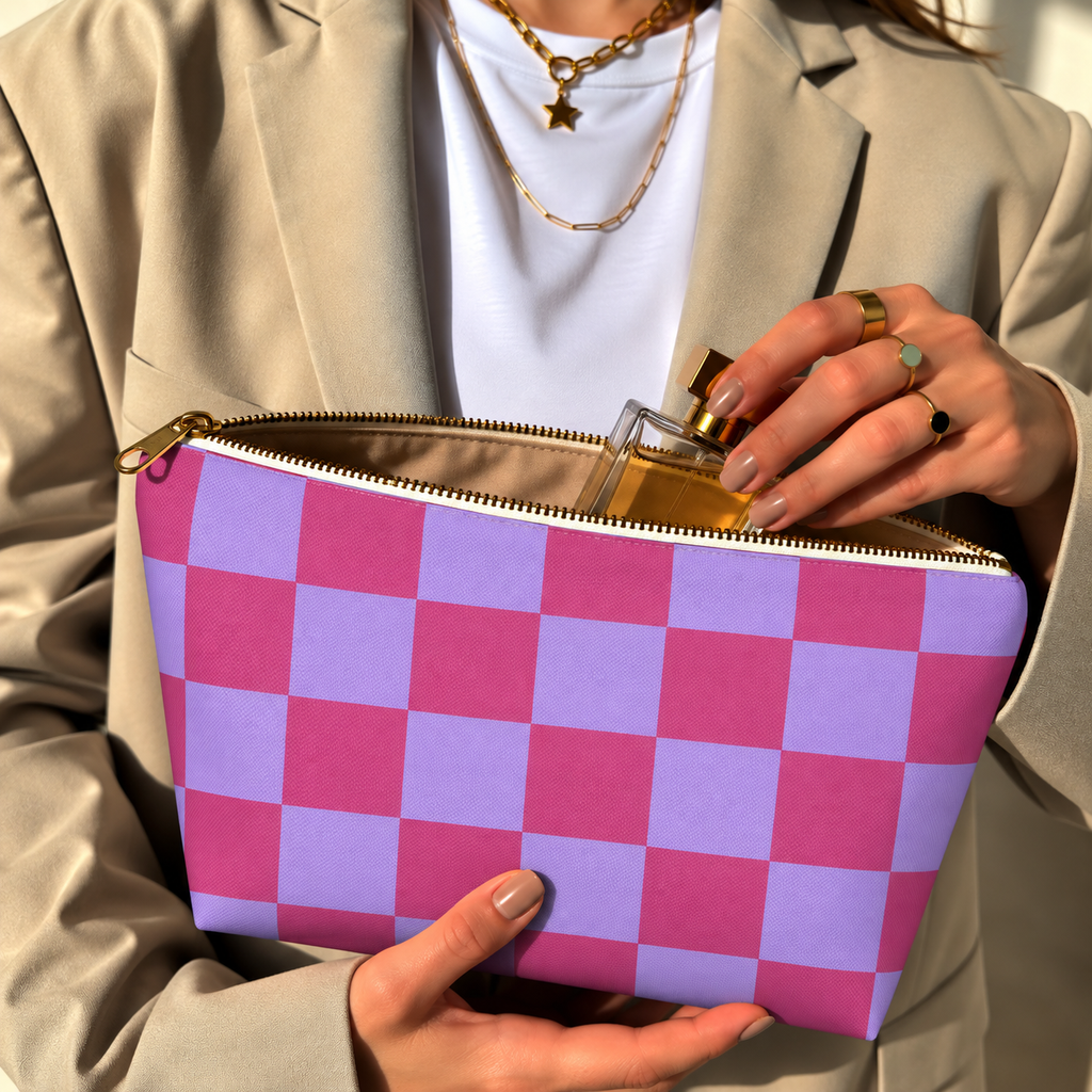 Woman holding the pink purple checkered makeup bag open with the gold zipper