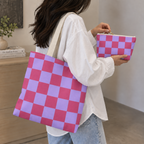 Woman carrying the matching tote bag and holding the pink purple checkered makeup bag