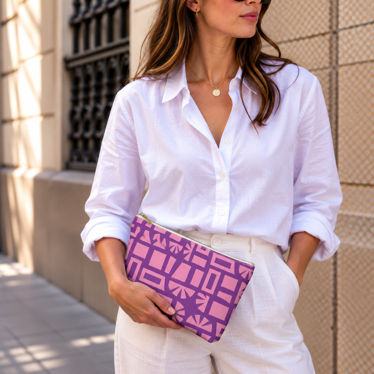 Woman in a white shirt holding the Pink Purple Geometric Print makeup bag