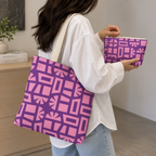 Woman carrying the Pink Purple Geometric Print tote bag on her shoulder with the matching makeup bag