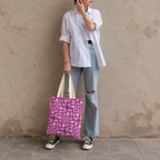 Model standing outdoors with the Pink Purple Geometric Print tote bag in a full-body photo