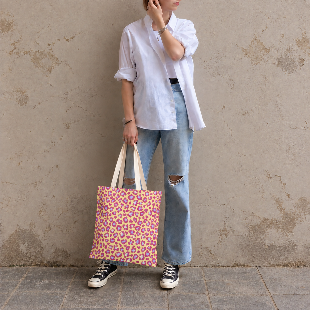 Woman in jeans and sneakers holding the pink purple leopard print tote bag