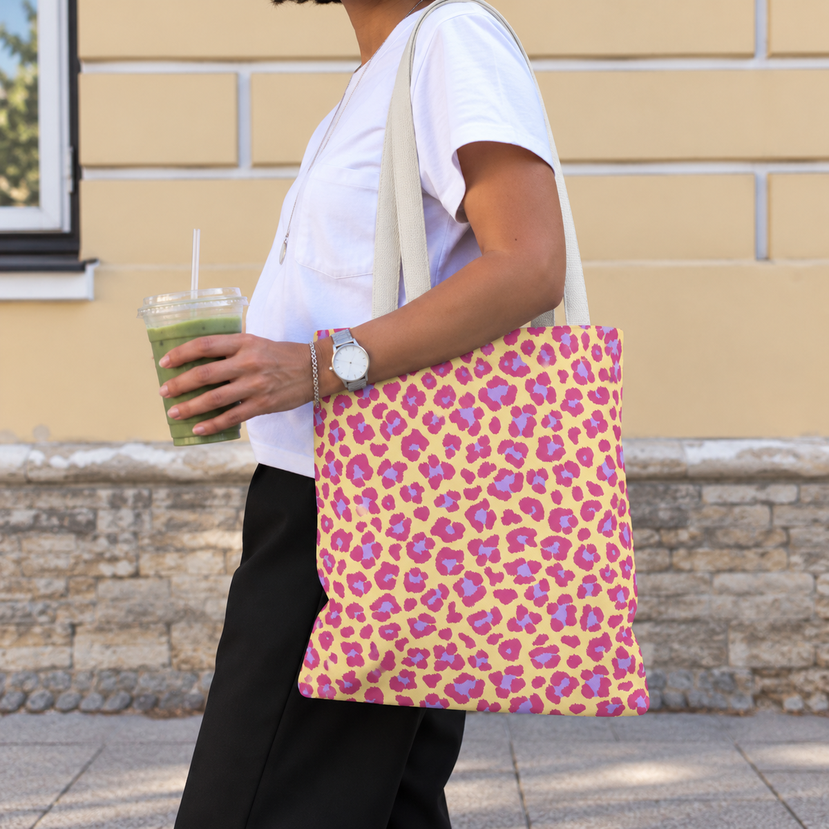 Woman walking with the pink purple leopard print tote bag on her shoulder