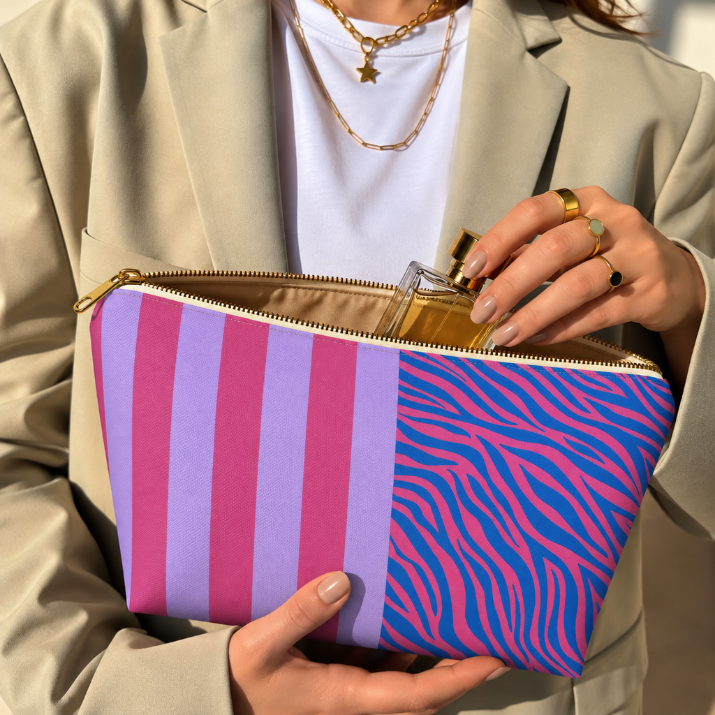 Woman holding the zebra stripe makeup bag open with a perfume bottle inside