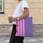 Woman walking with the pink purple zebra stripe tote bag on her shoulder and an iced drink
