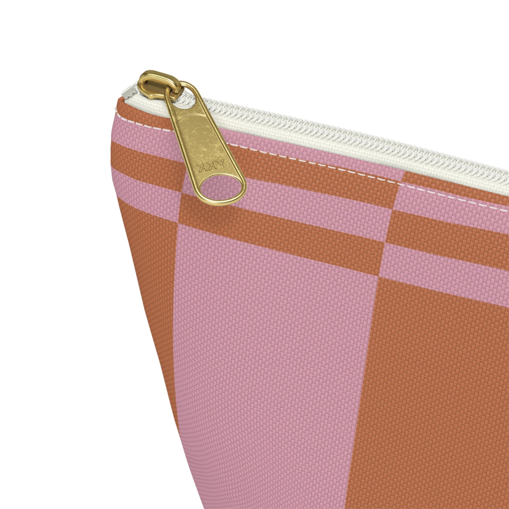 Close-up of the gold zipper pull on the pink terracotta color block makeup bag