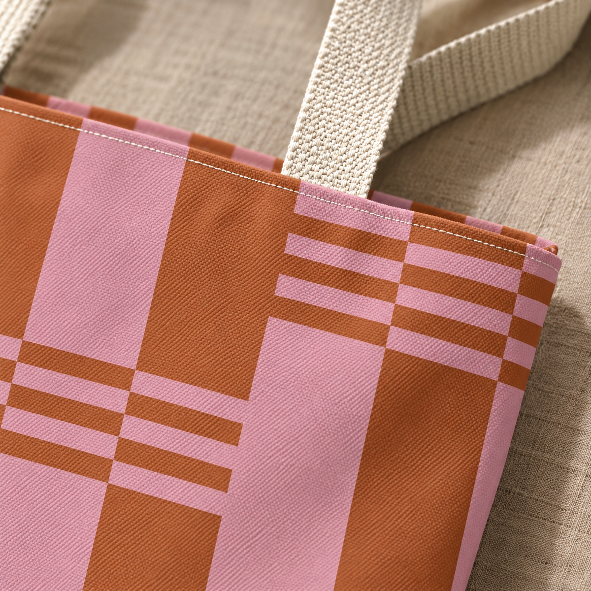 Close-up of the pink and terracotta blocks with beige handle on the tote bag