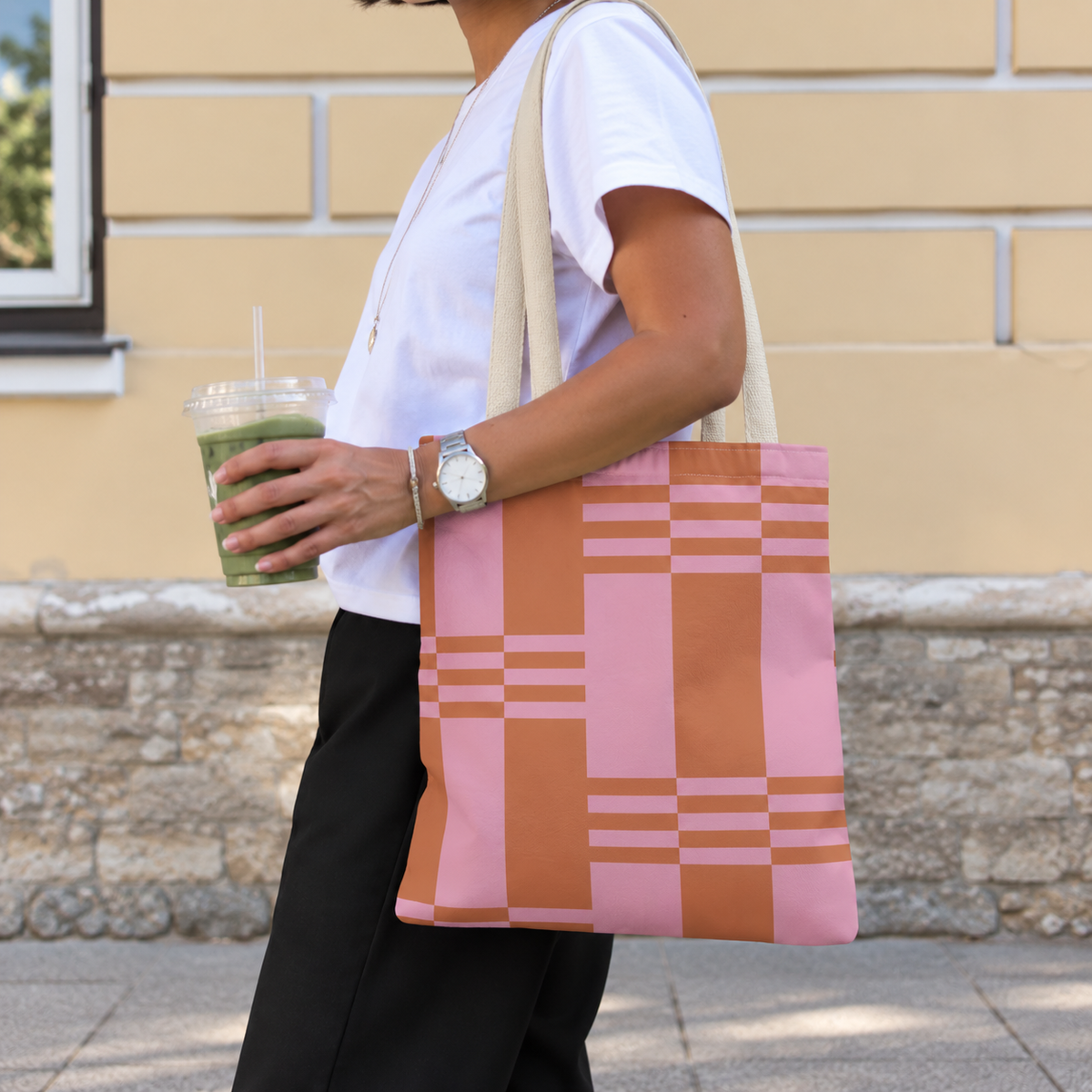 Side view of a model carrying the pink terracotta color block tote bag on the shoulder