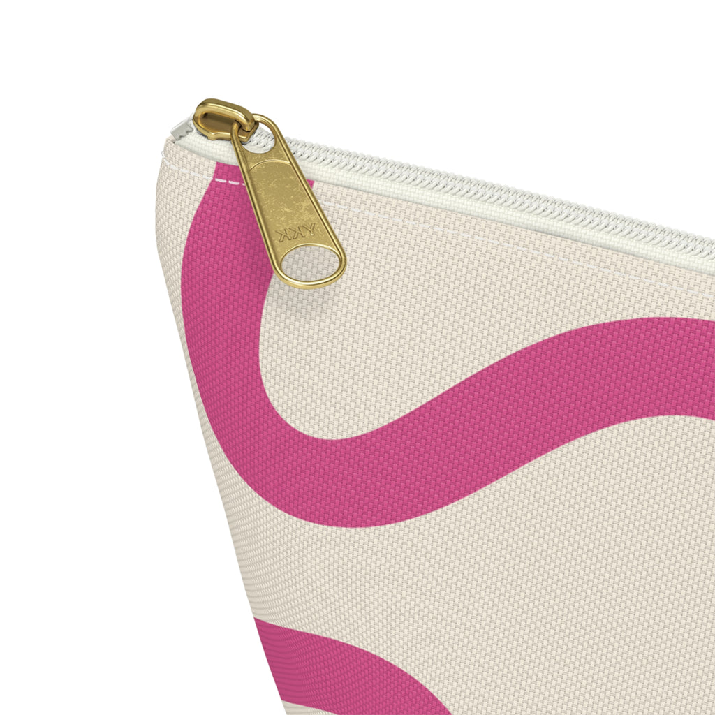 Close-up of the gold zipper pull on the pink wavy line makeup bag
