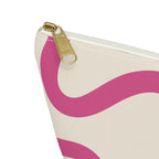 Close-up of the gold zipper pull on the pink wavy line makeup bag