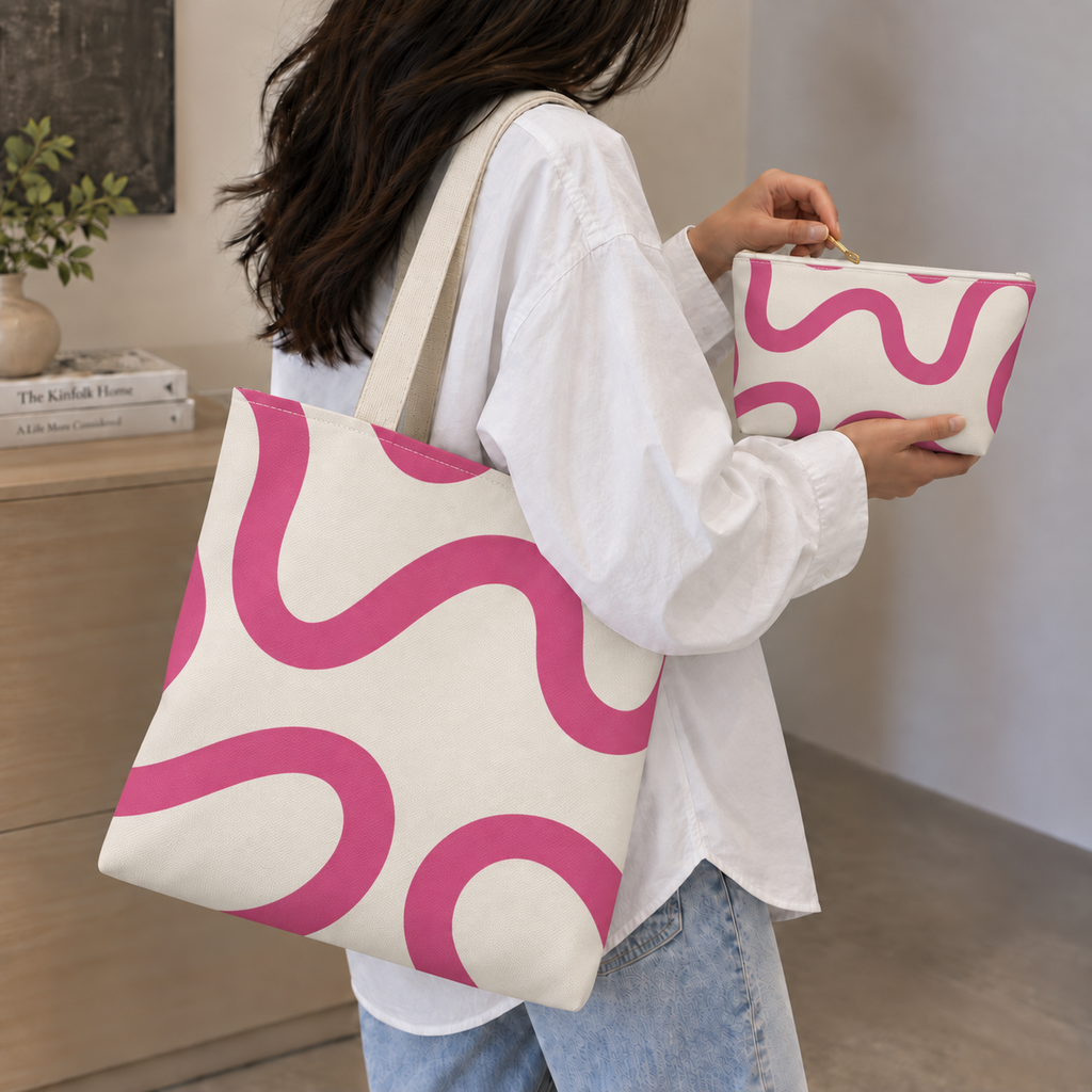 Woman holding the pink wavy line tote bag and matching makeup bag