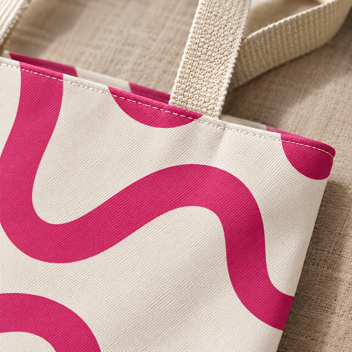 Close-up of the pink wavy line print and handle on the tote bag
