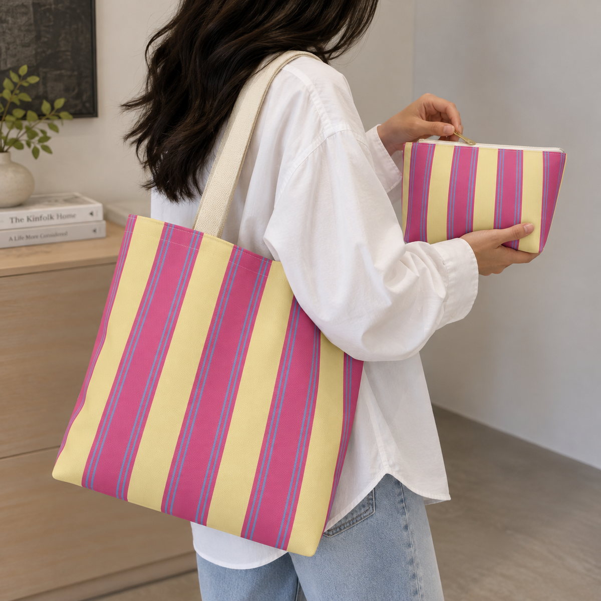 Model holding the Pink Yellow Striped tote bag with the matching makeup bag