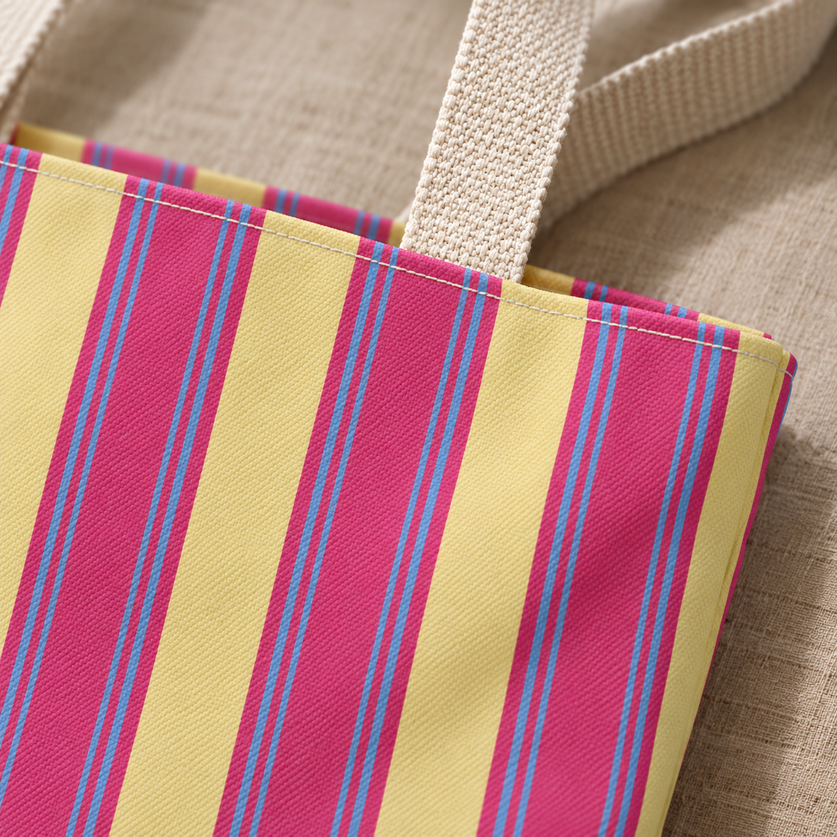 Close-up of the pink and yellow stripes and the handle of the striped tote bag