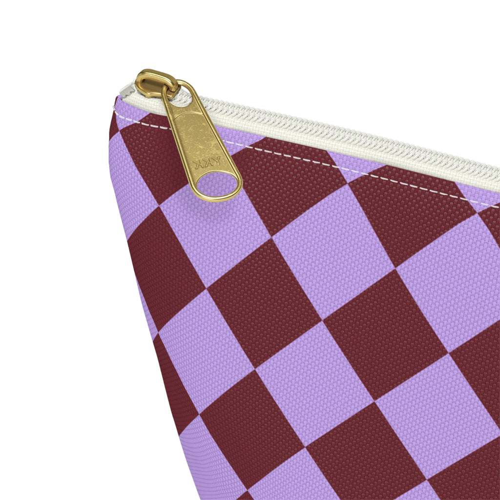 Close-up of the gold zipper pull and lilac burgundy diamond checks on the makeup bag