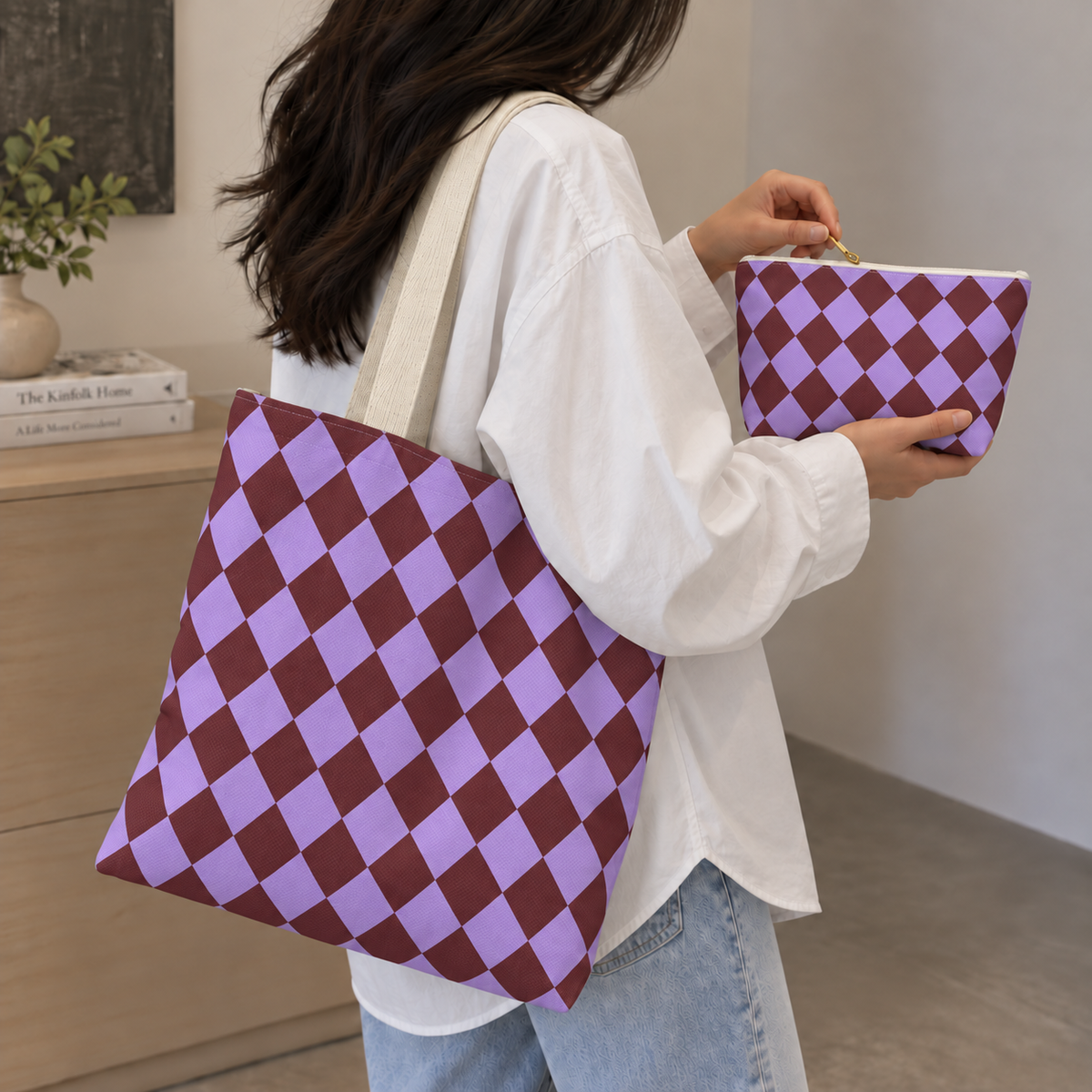 Purple burgundy checkered tote bag on the shoulder with a matching makeup bag in hand