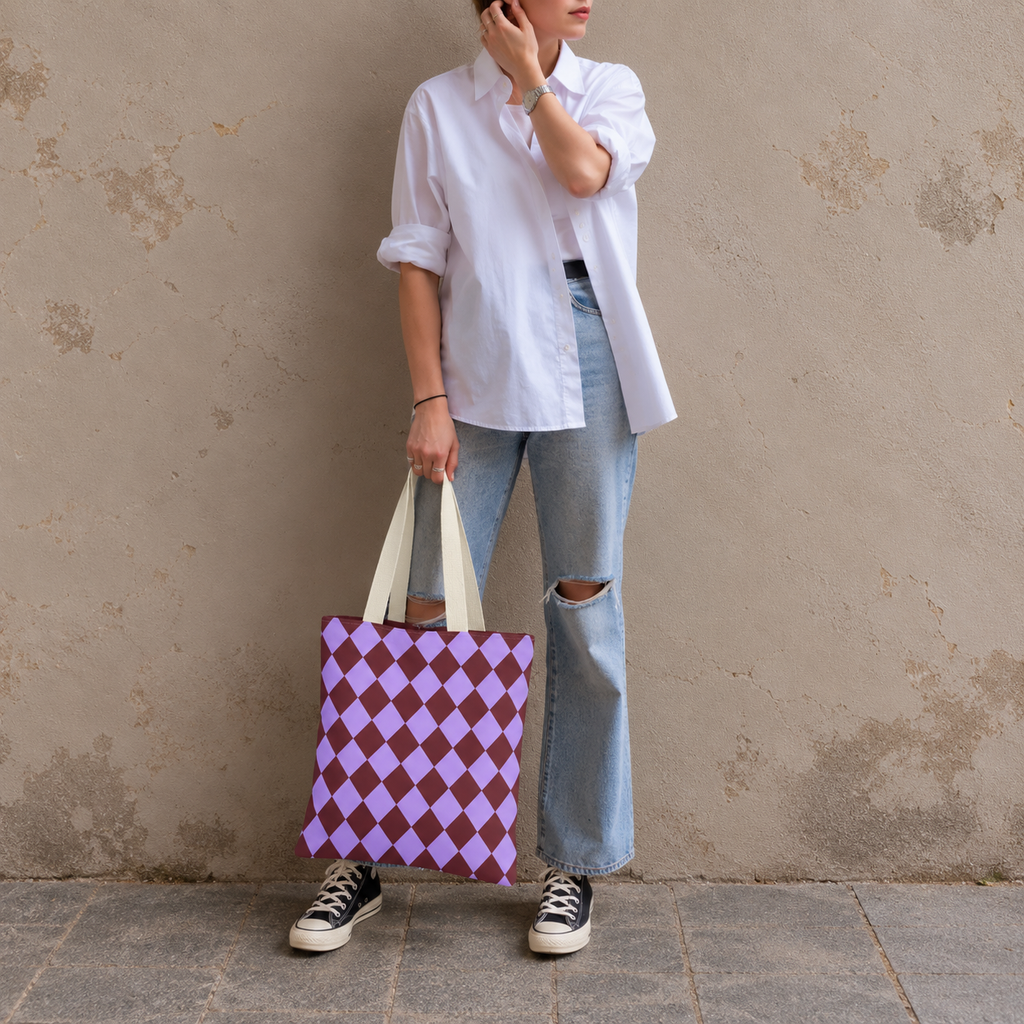 Woman in jeans and sneakers holding the purple burgundy diamond checkered tote bag