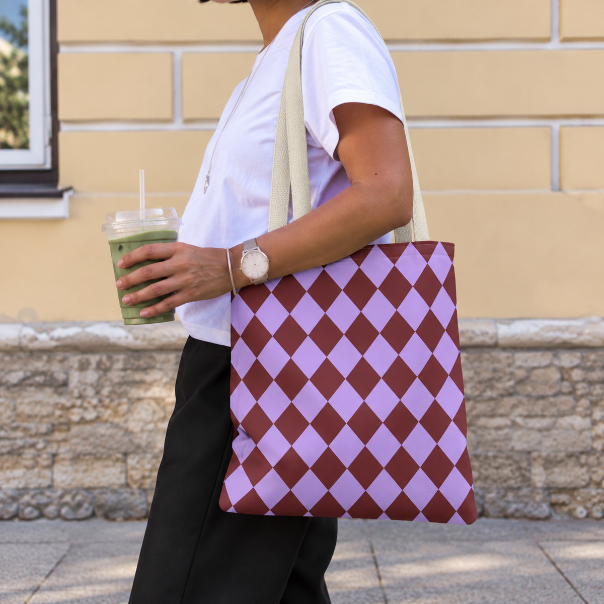Woman walking with the purple burgundy diamond checkered tote bag on her shoulder