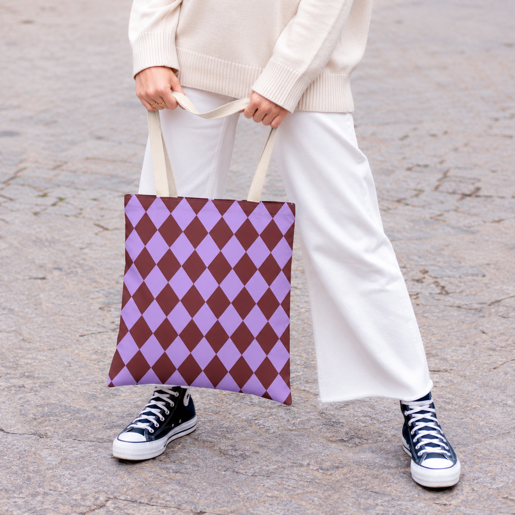 Woman in white trousers carrying the purple burgundy diamond checkered tote bag