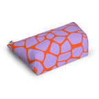 Side view of the purple orange giraffe print makeup bag lying down