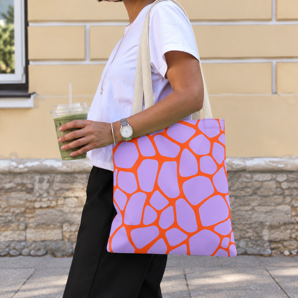Woman walking with the purple orange giraffe print tote bag on her shoulder
