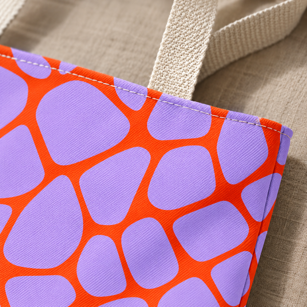 Close-up of lilac patches and orange lines next to the beige tote handle