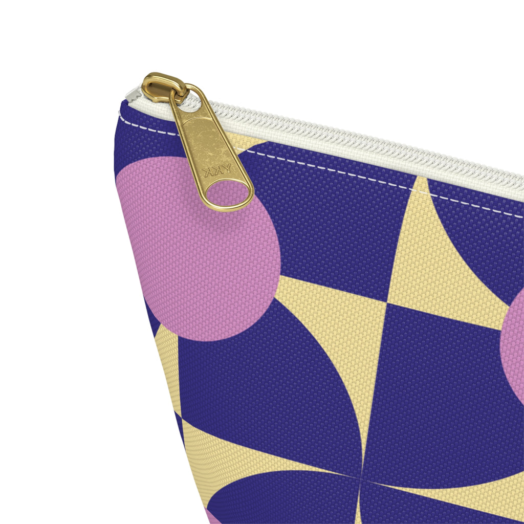 Close-up of the gold zipper pull on the purple pink geometric makeup bag