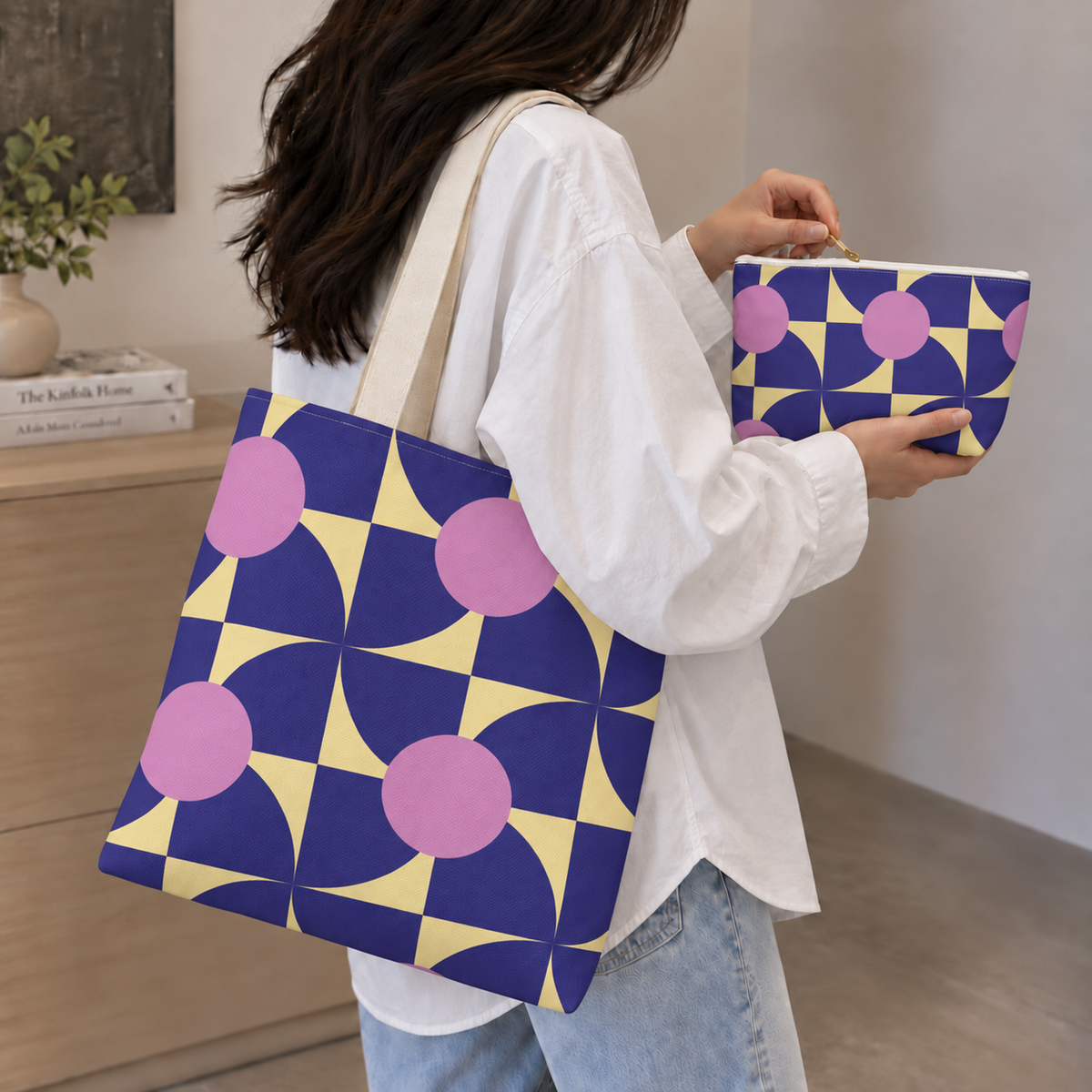 Woman holding the purple pink geometric tote bag and matching makeup bag