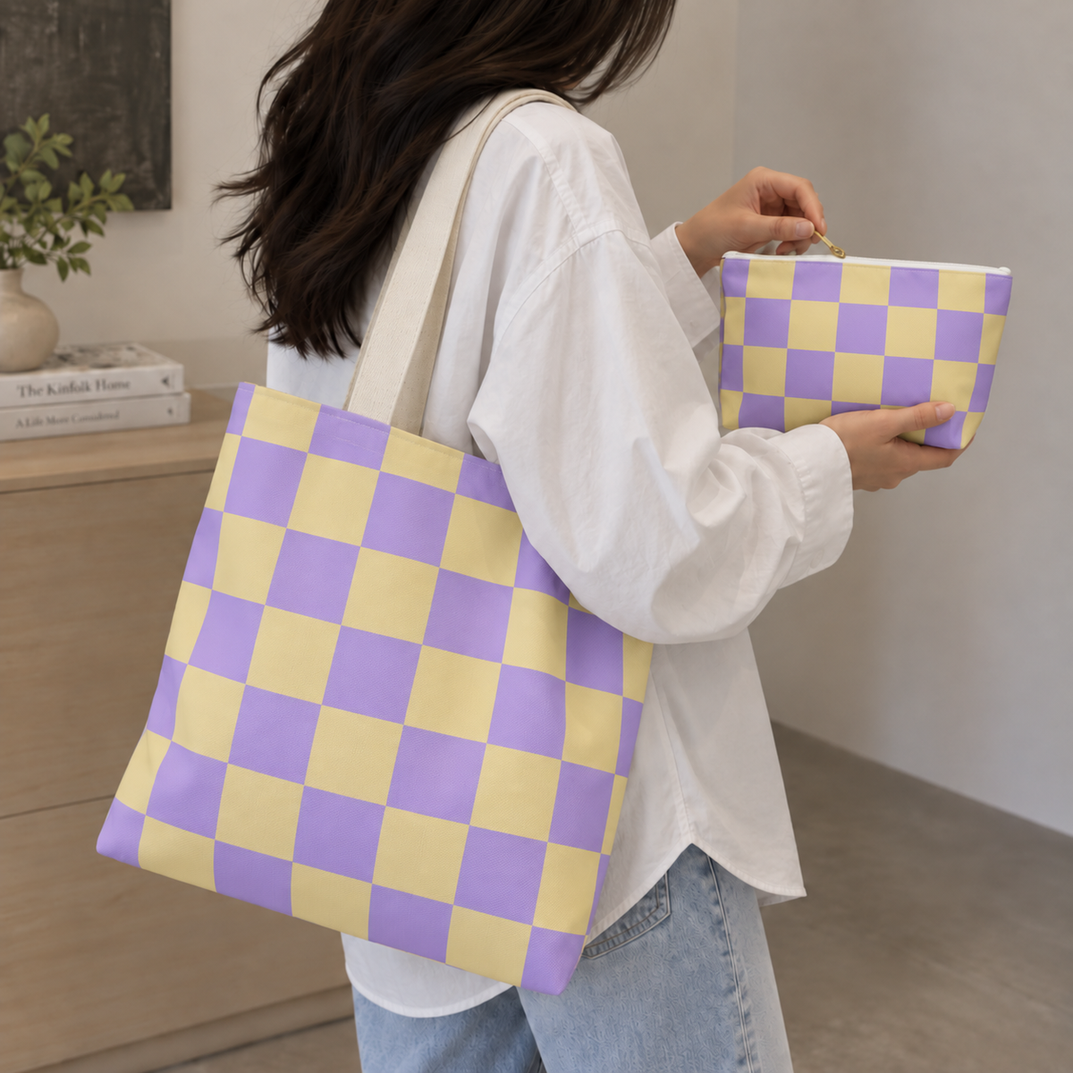 Woman carrying the matching tote bag and holding the purple yellow checkered makeup bag