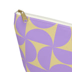 Close-up of the gold zipper pull on the purple yellow geometric makeup bag