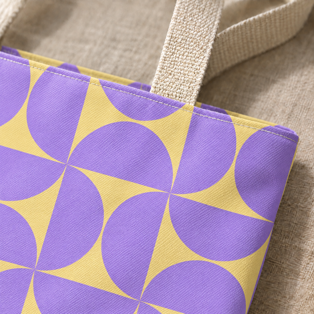 Close-up of the purple yellow geometric print and handle on the tote bag