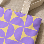 Close-up of the purple yellow geometric print and handle on the tote bag