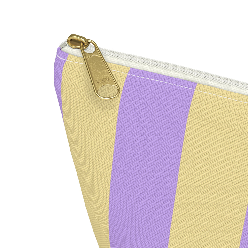 Close-up of the purple and yellow stripes and gold zipper pull on the makeup bag
