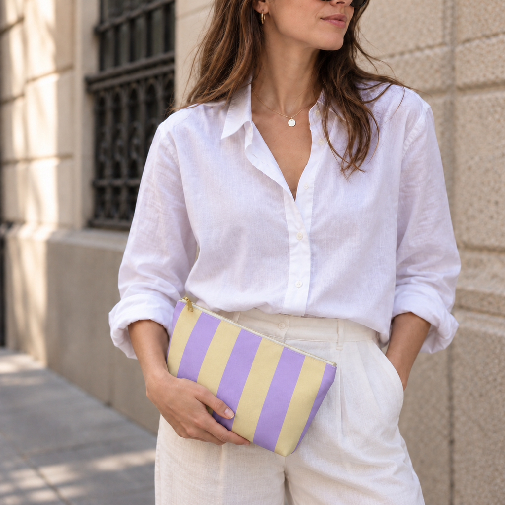 Model holding the Purple Yellow Striped makeup bag like a clutch