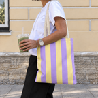 Woman walking with the Purple Yellow Striped tote bag on her shoulder