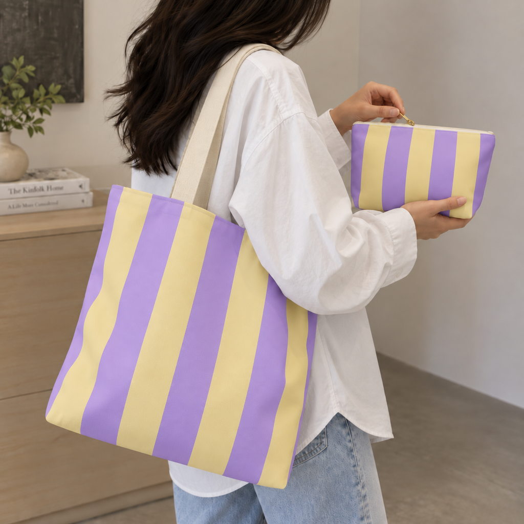 Model holding the Purple Yellow Striped tote bag with the matching makeup bag