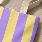 Close-up of the purple and yellow stripes and the handle of the striped tote bag