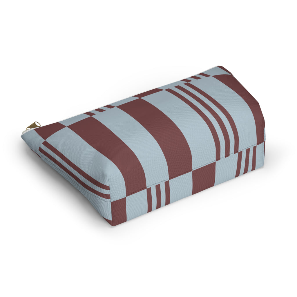 Sky blue burgundy block striped makeup bag lying on its side in an angled view