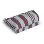 Sky blue burgundy block striped makeup bag lying on its side in an angled view