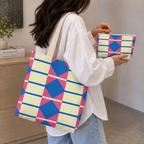 Woman carrying the matching geometric tote bag with the makeup bag in her hand